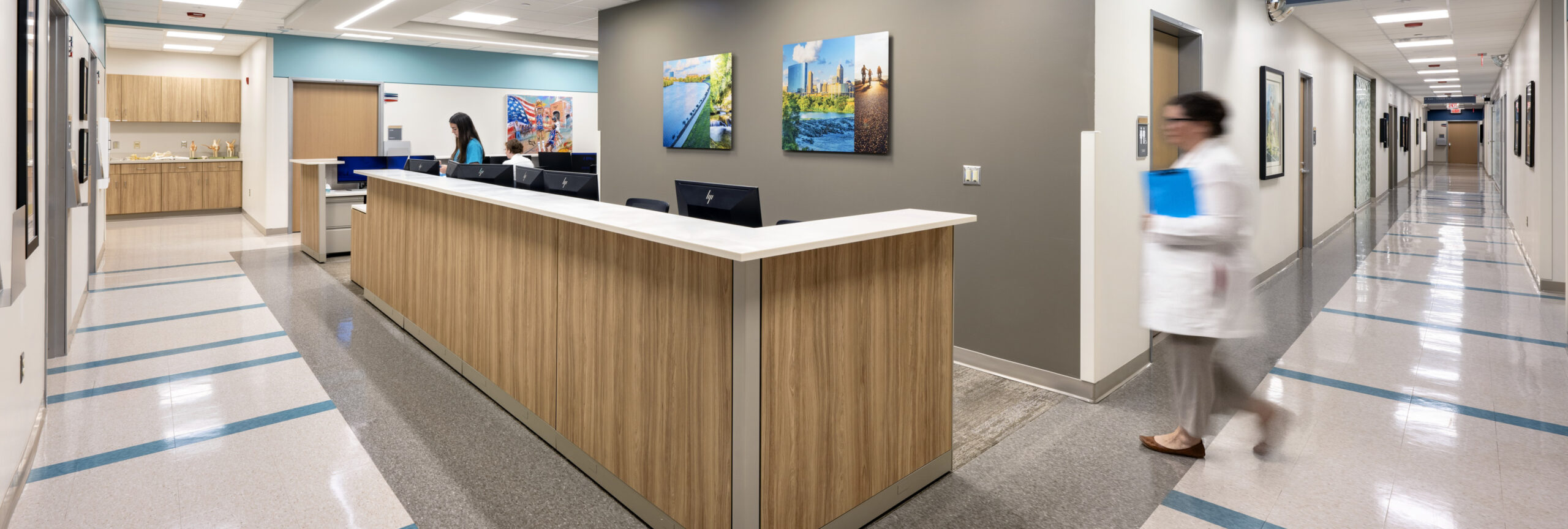 View of nurses station, corridor and flooring navigation using color contrast.