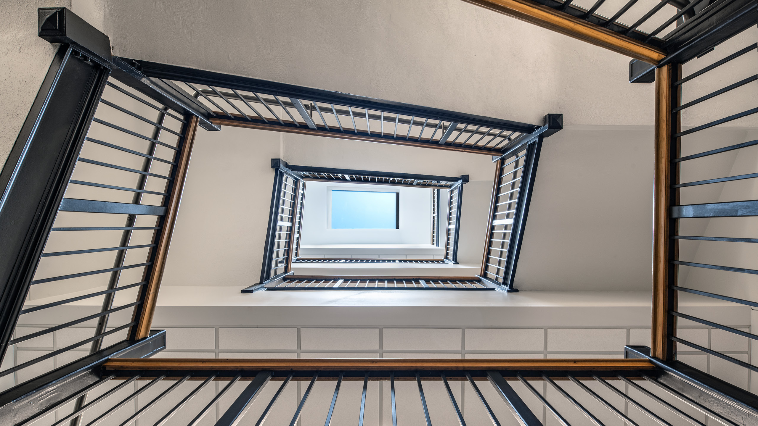 Purdue University Hall of Data Science and AI stair abstract looking up to sky light.